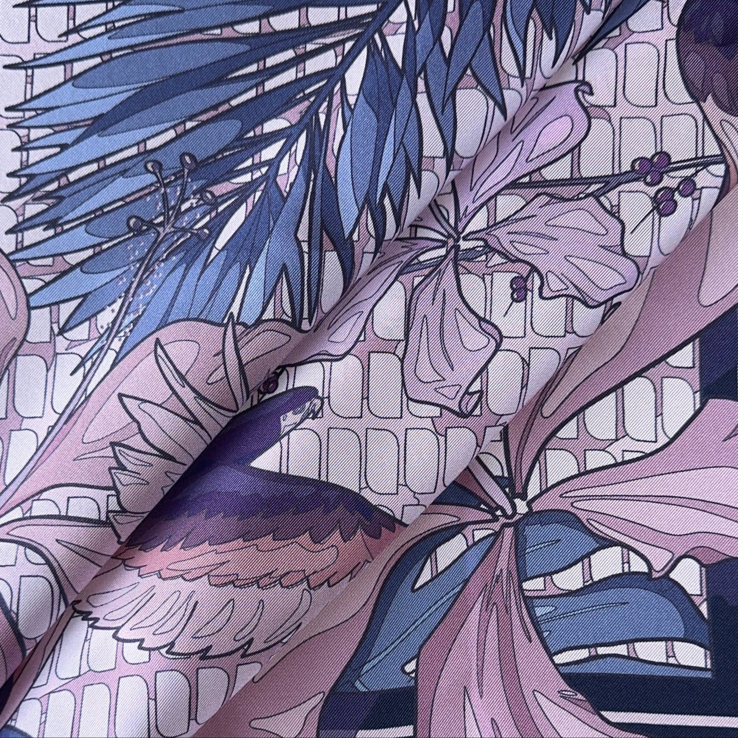 Detail of folds of a BLUEMATERIALS pink, purple, and navy blue pocket square