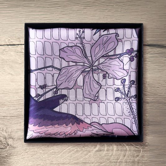 Pink purple, and navy blue pocket square folded in packaging on rustic wooden table