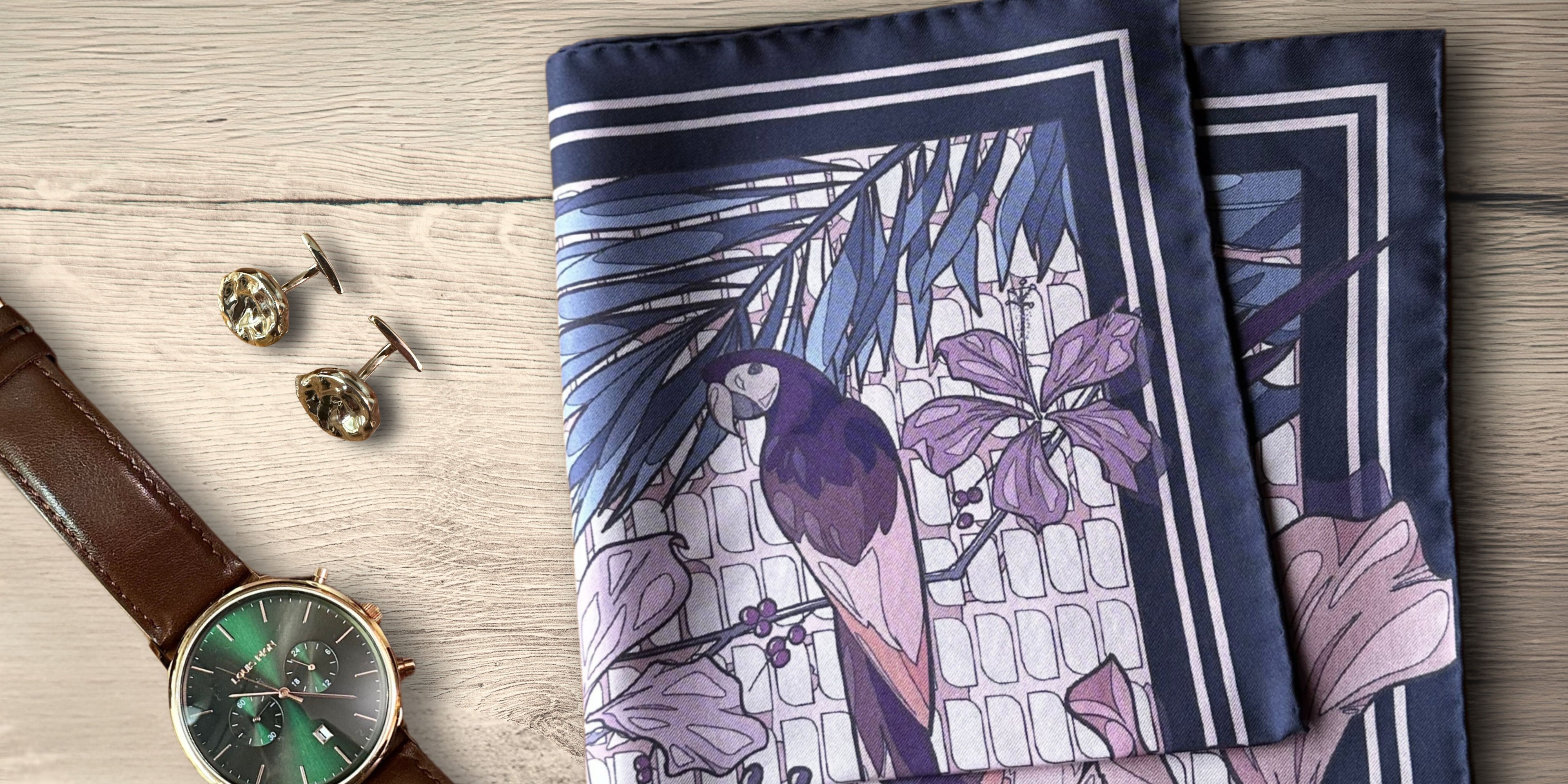 Luxury Silk Pocket Square with floral and bird design on a wooden surface with elegant watch and cufflinks.